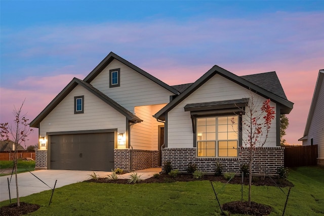 view of front of property with a garage and a lawn