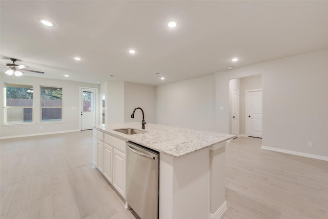 kitchen with white cabinets, sink, stainless steel dishwasher, an island with sink, and light hardwood / wood-style floors