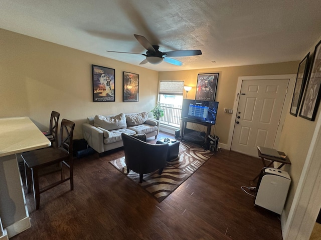 3022 Forest Ln Unit 221, Dallas, TX 75234 - living area featuring a ceiling fan, wood finished floors, baseboards, and a textured ceiling