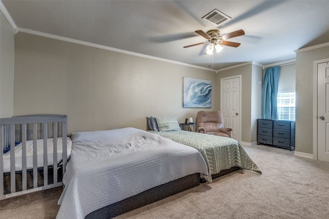 carpeted bedroom featuring ceiling fan and crown molding