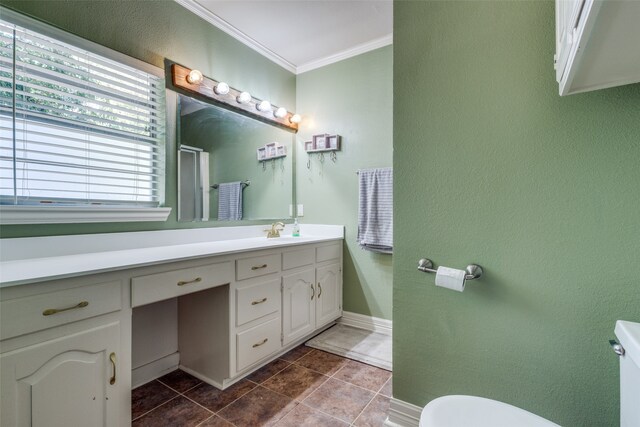 bathroom with crown molding, tile patterned flooring, and vanity