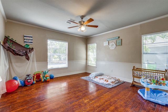 recreation room with ceiling fan, crown molding, and hardwood / wood-style floors