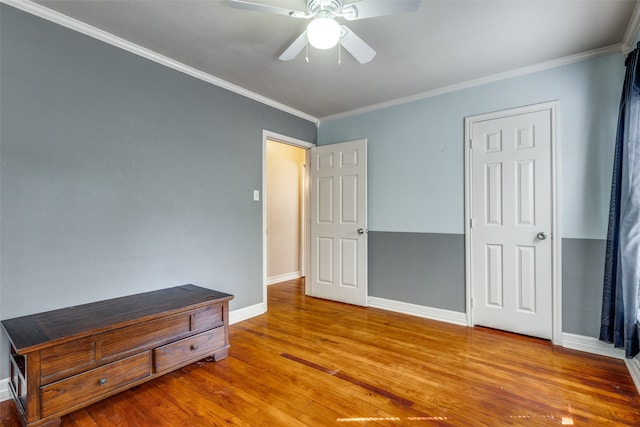 bedroom with ornamental molding, ceiling fan, and hardwood / wood-style flooring