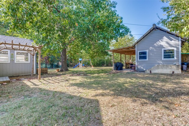 view of yard with a playground, a pergola, and a patio