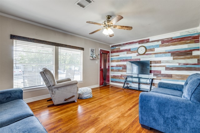 living room featuring ceiling fan, hardwood / wood-style flooring, and crown molding