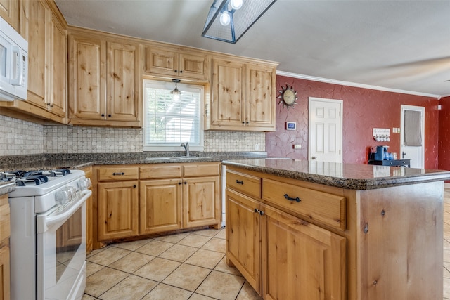 kitchen featuring white appliances, light tile patterned floors, a center island, ornamental molding, and sink