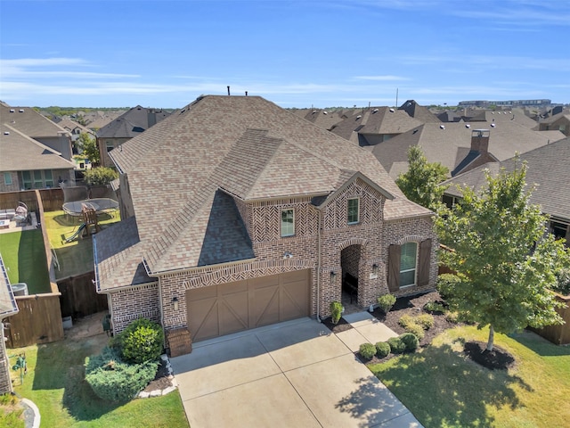 view of front of property with a garage and a front lawn