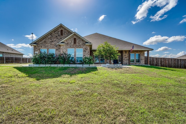 view of front of home featuring a patio and a front lawn