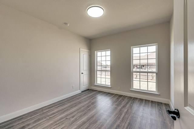 spare room with dark hardwood / wood-style floors