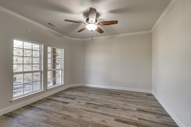 unfurnished room featuring ceiling fan, light wood-type flooring, and crown molding