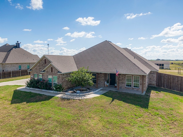 view of front of property with a patio and a front lawn