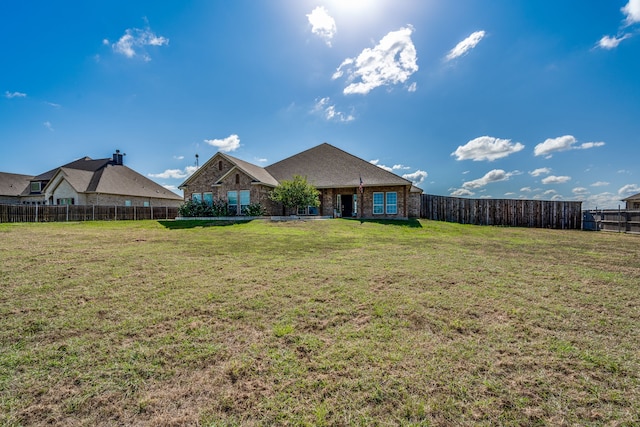 rear view of property with a yard