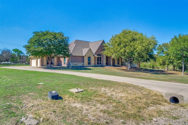 view of front of home with a front yard and a garage