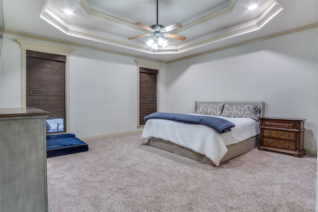 carpeted bedroom with a raised ceiling and ornamental molding