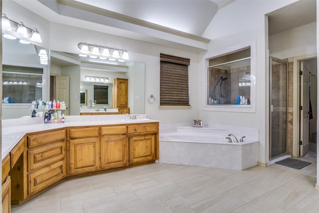 bathroom with shower with separate bathtub, vanity, and vaulted ceiling