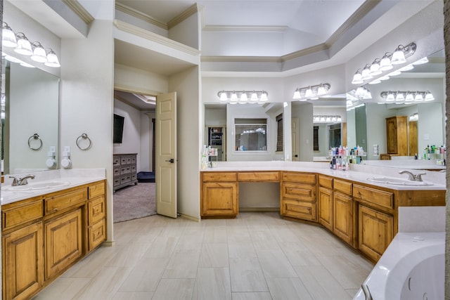 bathroom featuring vanity, a bathing tub, and ornamental molding