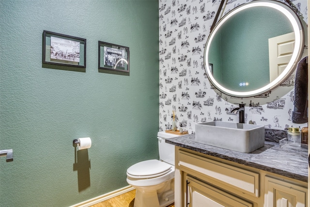 bathroom featuring vanity, toilet, and hardwood / wood-style flooring