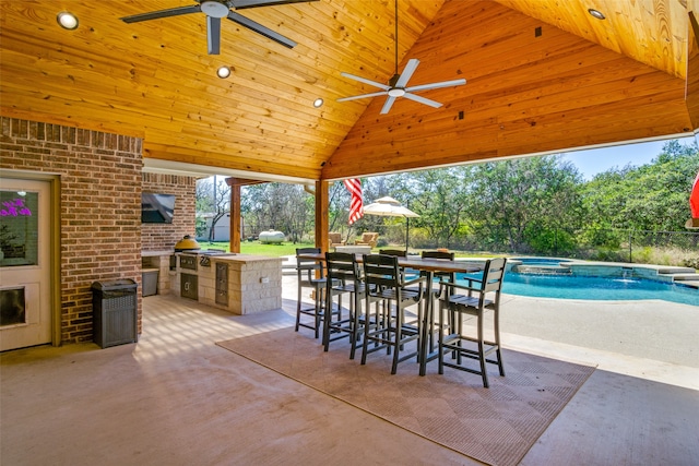 view of patio featuring a swimming pool with hot tub, a gazebo, area for grilling, and ceiling fan