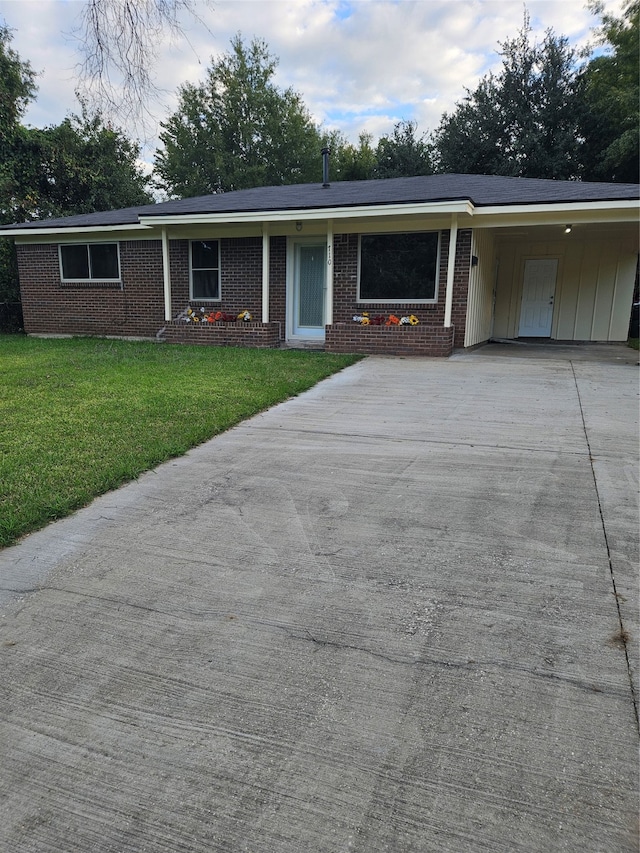 ranch-style house with a carport and a front yard