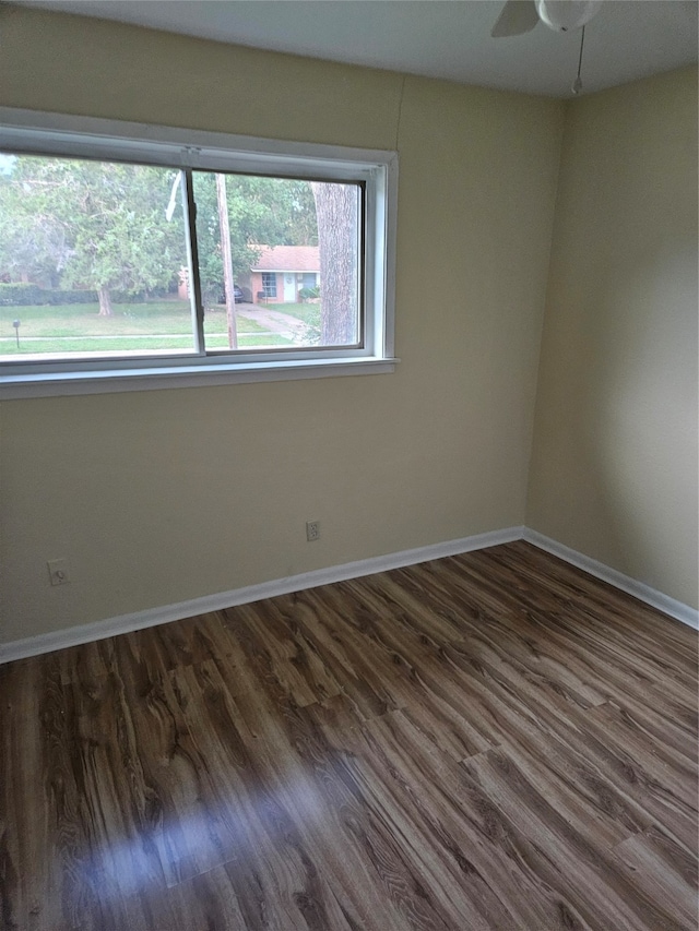 spare room with ceiling fan and dark hardwood / wood-style floors