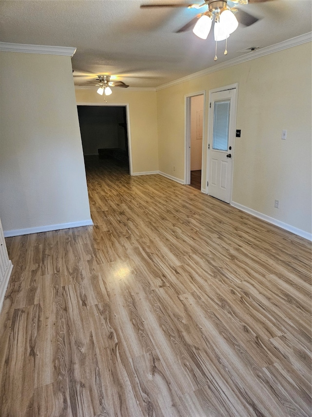 empty room featuring light wood-type flooring, crown molding, a textured ceiling, and ceiling fan