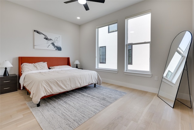 bedroom with ceiling fan and light hardwood / wood-style flooring