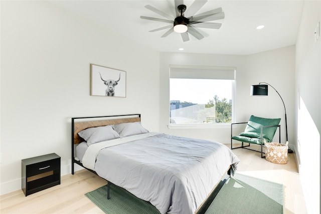 bedroom featuring ceiling fan and light hardwood / wood-style flooring