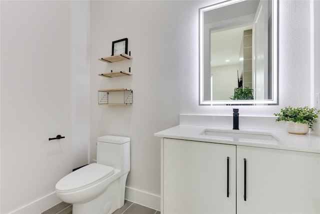 bathroom with tile patterned floors, vanity, and toilet