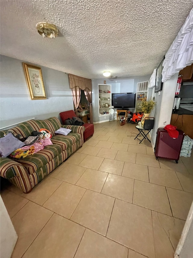 living room with a textured ceiling and light tile patterned flooring