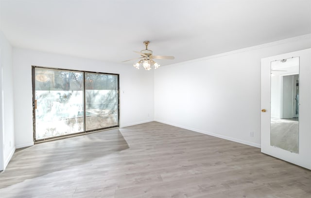 empty room with ceiling fan and light hardwood / wood-style floors