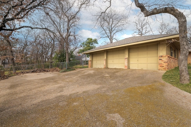 view of side of property featuring a garage and an outdoor structure