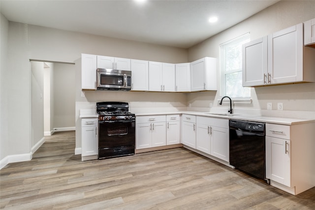 kitchen with white cabinets, light wood-type flooring, sink, and black appliances