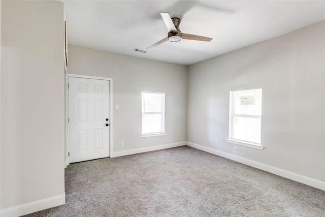 carpeted spare room with ceiling fan