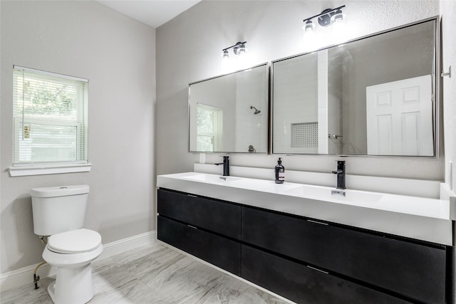 bathroom with walk in shower, vanity, and toilet