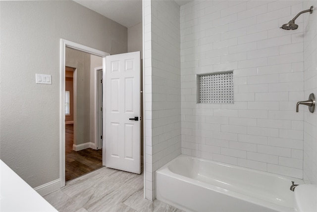 bathroom with tiled shower / bath combo and hardwood / wood-style floors