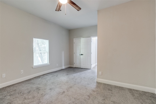 carpeted empty room featuring ceiling fan