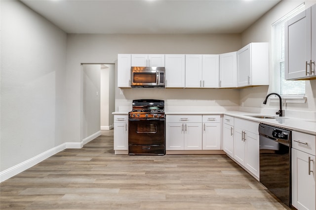 kitchen with sink, light hardwood / wood-style flooring, white cabinetry, and black appliances