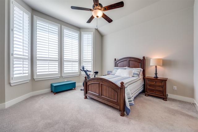 bedroom with light colored carpet, vaulted ceiling, and ceiling fan