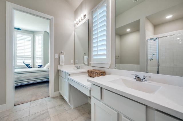 bathroom with tile patterned flooring, vanity, and a shower with shower door