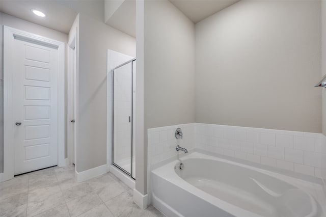 bathroom featuring tile patterned floors and separate shower and tub