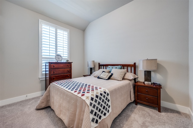 carpeted bedroom with lofted ceiling