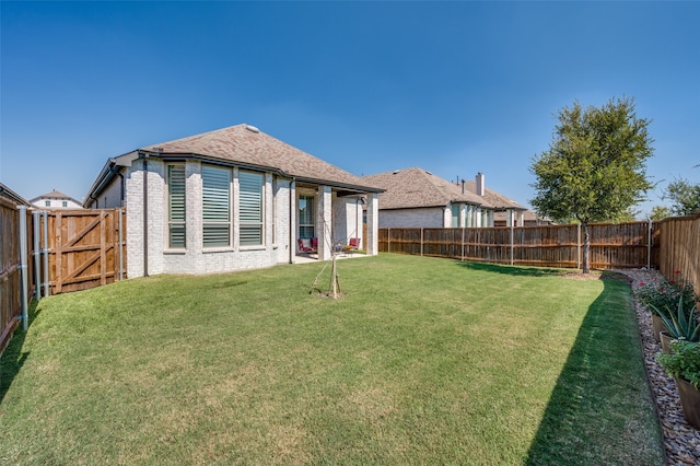 rear view of property featuring a lawn