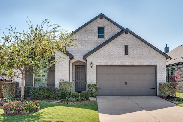 view of front of home featuring a garage and a front yard