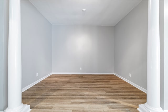 bonus room with light hardwood / wood-style flooring and ornate columns