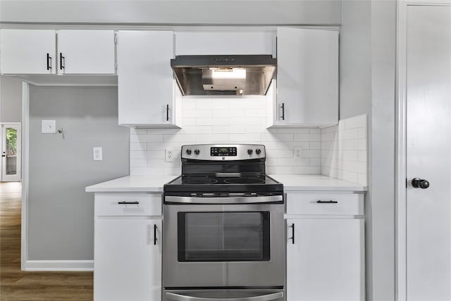 kitchen featuring electric stove, white cabinets, backsplash, and dark hardwood / wood-style floors