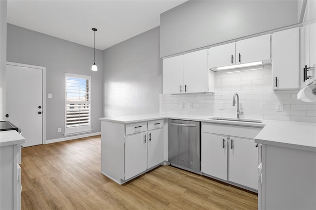 kitchen with hanging light fixtures, white cabinetry, light wood-type flooring, stainless steel dishwasher, and sink