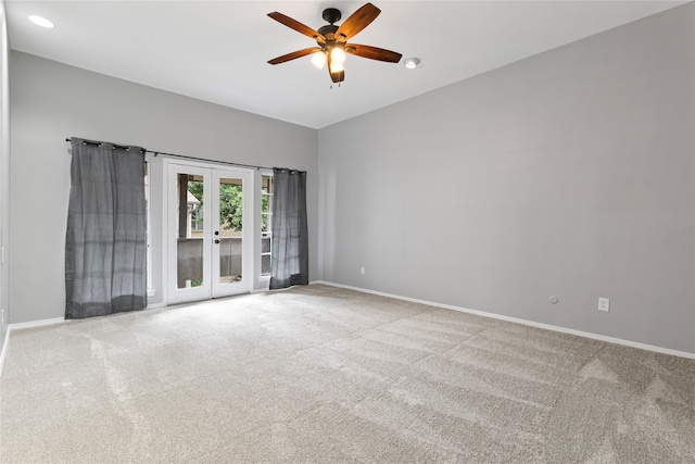 carpeted empty room with ceiling fan and french doors