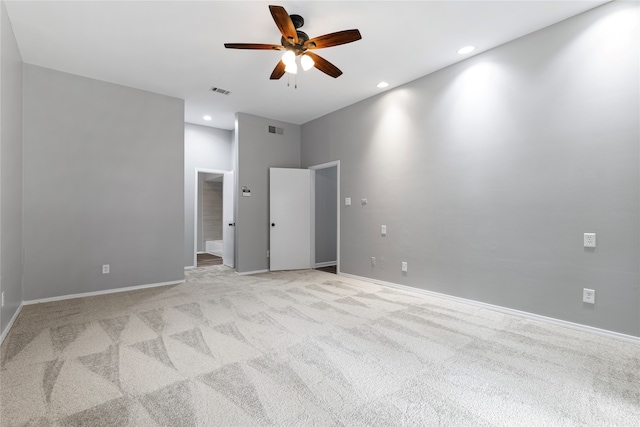 spare room with light carpet and ceiling fan