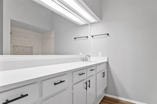 bathroom featuring walk in shower, vanity, and hardwood / wood-style floors