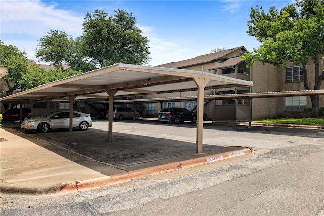 view of parking / parking lot featuring a carport